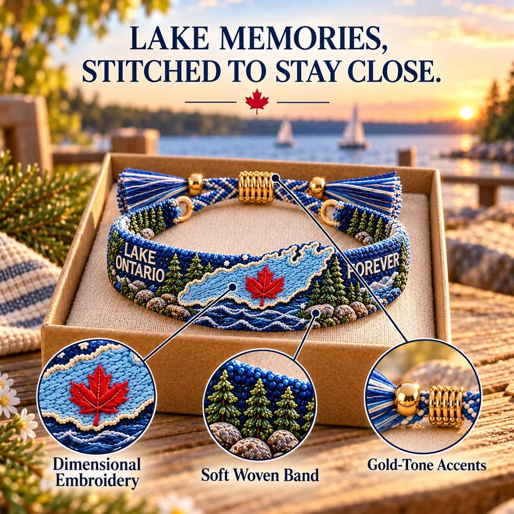 Close-up of embroidered lake artwork, soft woven band and gold-tone details